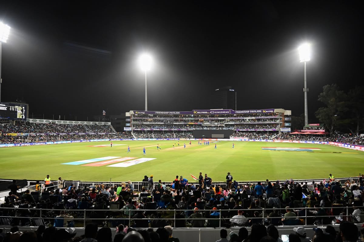 Kingsmead Cricket Ground in Durban during a floodlit match, with spectators surrounding the outfield.